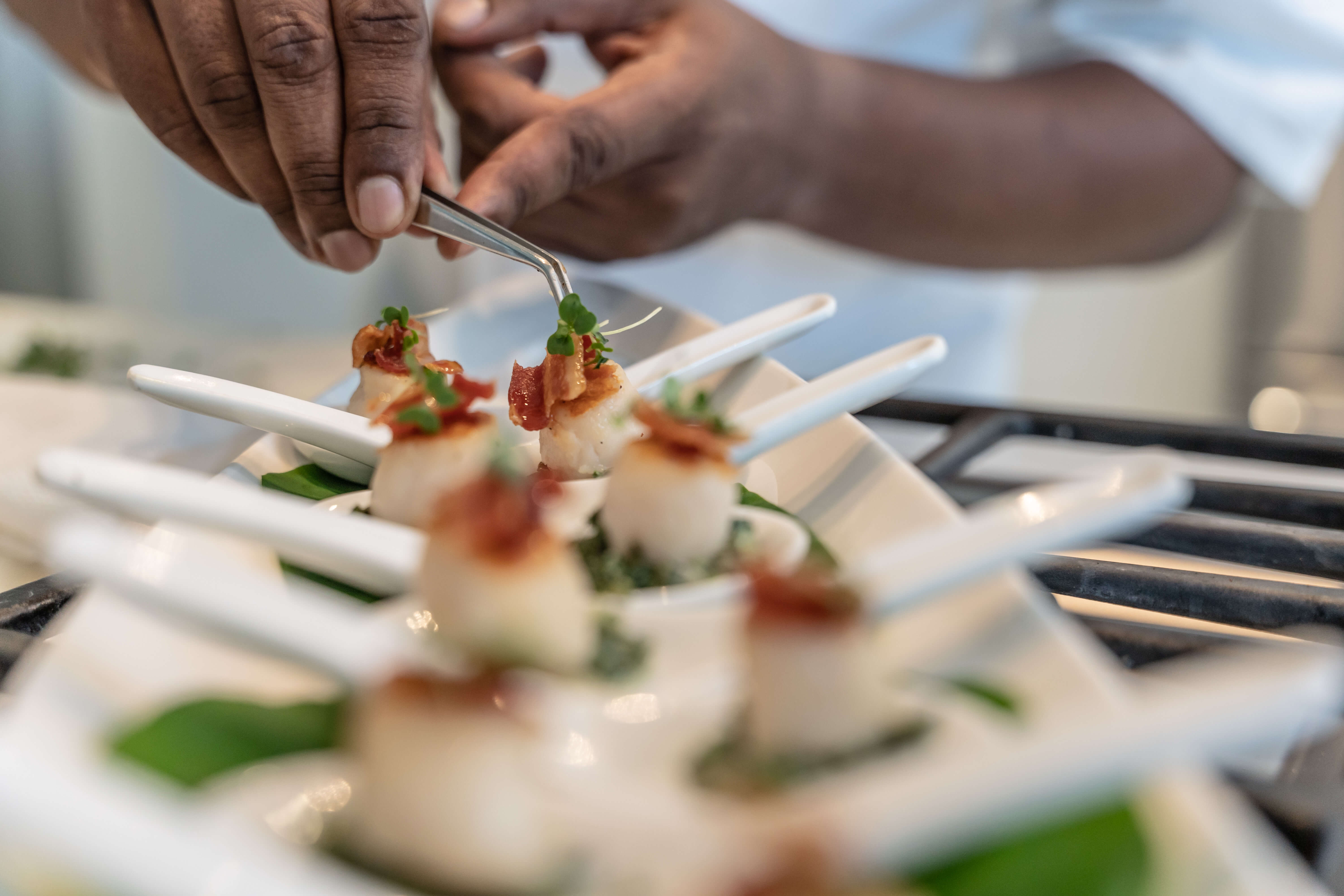 6 mise en place cayman chef decorating seared scallop passed canapes